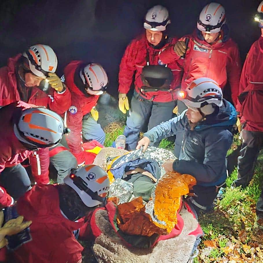 Team members training rope skills in the dark.